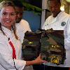 MAYPORT, Fla. (Nov. 13, 2007) Chef Cat Cora, from Food Networks Iron Chef America, proudly displays a set of BDUs with her name, which she received from Naval Mobile Construction Battalion Gulfport, Mississippi, team m