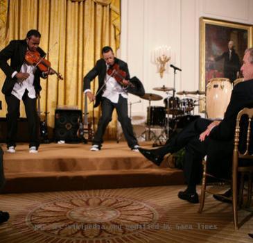 President George W. Bush and guests watch violinists Tourie and Damien Escobar of Nuttin’ But Stringz, as they perform Friday, June 22, 2007 in the East Room of the White House, in celebration of Black Music Month.