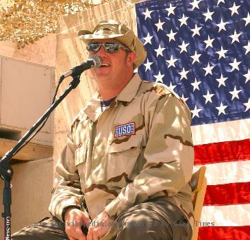 BAGHDAD, Iraq -- Gary LeVox, lead singer for country music group Rascal Flatts, performs for Airmen and Soldiers at Baghdad International Airport on Aug. 5 from a make-shift stage behind a building that was once Saddam Hussein