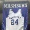 A jersey honoring Jamal Mashburn hangs in Rupp Arena