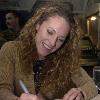 050330-N-8119C-004 Pacific Ocean (Mar. 31, 2005) - Jerri Manthey of the hit television show “Survivor,” signs autographs and talks to crew members aboard the nuclear powered aircraft carrier USS Nimitz (CVN 68). Nimitz is currently conducting Fleet Re