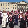 Norwegians dressed in bunad parading in front of the royal family on May 17th.