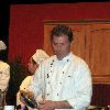 Bobby Flay performing a cooking demonstration in Green Bay, Wisconsin