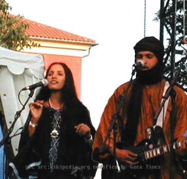 Photo of the Tuareg musical group Tinariwen, taken at the Nice Jazz Festival in Nice, France. Photo altered slightly to remove advertising in the background and bring the musicians slightly closer together.