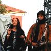 Photo of the Tuareg musical group Tinariwen, taken at the Nice Jazz Festival in Nice, France. Photo altered slightly to remove advertising in the background and bring the musicians slightly closer together.