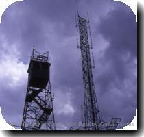 The 9 256 foot summit of Bill Williams Mountain bristles with an array of communication towers  in addition to the fire lookout tower silhouetted against the dark sky in this picture