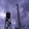 The 9 256 foot summit of Bill Williams Mountain bristles with an array of communication towers  in addition to the fire lookout tower silhouetted against the dark sky in this picture