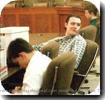 Previous | Next   Three teen agers charged with murdering three 8 year old boys in West Memphis  Ark   sit in a Jonesboro  Ark   courtroom Tuesday  Oct  19  1993  Damien Echols  18  looks over his shoulder