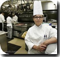 WhiteHouse Chef Cristeta Comerford pauses during preparation for a meal in the WhiteHouse kitchen in Washington
