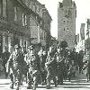 POWs are marched to Stalag Luft I from the railroad station through the town of Barth  En route they pass through the Dammtor Gate  as seen in the background of this photo  The gate