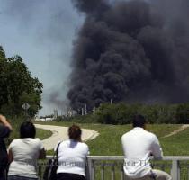 People watch the AGE refinery fire Wednesday May 5  2010 in San Antonio from a bridge south of the fire  An 18 wheeler being loaded with fuel at a San Antonio refinery exploded Wednesday  setting off a chain reaction of smaller explosions and sending a towering plume of thick black smoke over the city  southeast side  One person was critically burned  and the driver of the exploding truck remained missing   AP Photo San Antonio Express News  John Davenport  MAGS OUT  TV OUT  NO SALES  SAN ANTONIO OUT  MANDATORY CREDIT 2010 05 06 06 41 05  People watch the AGE refinery fire Wednesday May 5  2010 in San Antonio from a bridge south of the fire  An 18 wheeler being loaded with fuel at a San Antonio refinery exploded Wednesday  setting off a chain reaction of smaller explosions and sending a towering plume of thick black smoke over the city  southeast side  One person was critically burned  and the driver of the exploding truck remained missing   AP Photo San Antonio Express News  John Davenport  MAGS OUT  TV OUT  NO SALES  SAN ANTONIO OUT  MANDATORY CREDIT 2010 05 06 06 41 05