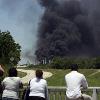 People watch the AGE refinery fire Wednesday May 5  2010 in San Antonio from a bridge south of the fire  An 18 wheeler being loaded with fuel at a San Antonio refinery exploded Wednesday  setting off a chain reaction of smaller explosions and sending a towering plume of thick black smoke over the city  southeast side  One person was critically burned  and the driver of the exploding truck remained missing   AP Photo San Antonio Express News  John Davenport  MAGS OUT  TV OUT  NO SALES  SAN ANTONIO OUT  MANDATORY CREDIT 2010 05 06 06 41 05  People watch the AGE refinery fire Wednesday May 5  2010 in San Antonio from a bridge south of the fire  An 18 wheeler being loaded with fuel at a San Antonio refinery exploded Wednesday  setting off a chain reaction of smaller explosions and sending a towering plume of thick black smoke over the city  southeast side  One person was critically burned  and the driver of the exploding truck remained missing   AP Photo San Antonio Express News  John Davenport  MAGS OUT  TV OUT  NO SALES  SAN ANTONIO OUT  MANDATORY CREDIT 2010 05 06 06 41 05