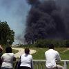 <p>People watch the AGE refinery fire Wednesday May 5  2010 in San Antonio from a bridge south of the fire  An 18 wheeler being loaded with fuel at a San Antonio refinery exploded Wednesday  setting off a chain reaction of smaller explosions and sending a towering plume of thick black smoke over the city s southeast side  One person was critically burned  and the driver of the exploding truck remained missing   AP Photo San Antonio Express News  John Davenport  MAGS OUT  TV OUT  NO SALES  SAN ANTONIO OUT  MANDATORY CREDIT< p>