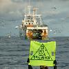 Targeting the bottom trawlers  destruction on the high seas A Greenpeace activist protests against the EU deep sea bottom trawler Playa de Menduina  fishing in the North Atlantic  Greenpeace is protesting against the destruction caused by this fishing