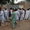 <p>Residents and media gather outside the ancestral home of the family of Faisal Shahzad  a Pakistani American held in New York on suspicion of driving a bomb laden car into Times Square  in the village of Mohib Banda  near the main northwestern city of Peshawar  May 5  2010  < p>