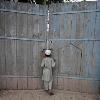 <p>A boy looks through the main gate of the ancestral home of the family of Faisal Shahzad  a Pakistani American held in New York on suspicion of driving a bomb laden car into Times Square  in Mohib Banda  in Pakistan  north western Khyber Pakhtoonkhwa province  May 5  2010  < p>