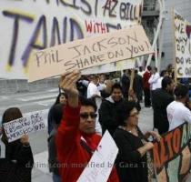 <p>People protest Arizona  new immigration law outside the Staples center prior to the start of Game 1 of the NBA Western Conference final playoff series between the Los Angeles Lakers and the Phoenix Suns in Los Angeles May 17  2010  The man is holding a sign criticizing Lakers coach Phil Jackson as Jackson had said in an interview he saw no problem with the new immigration law  REUTERS Danny Moloshok < p>