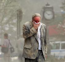 Edward Fine covers his mouth as he walks through the debris after the collapse of one of the World Trade Centre Towers in New York on September 11  2001  File photo    AFP  Stan Honda