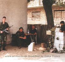 British Volunteer  holding AK 47  and three Bosnian Croatian members of the unit at the base  The base was located at the old school house in Sijekovac on the