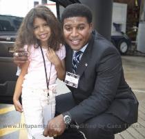 Photo Gallery CBS Sports Analyst and former NFL player  Spencer Tillman  poses with one of our young Honored Guests at a LUA event this year   Photo by Doug Layton