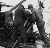 Workers operate a drill tilted at a 45 degree angle to cut across rock strata in the bed of Crawford Pond in Piscataquis County  Maine   The BOSTON GLOBE FILE 1960  By