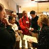 Museum docent and group leader  Gabriella Cantoni  hands out educational bookmarks to students from Suitland High School in Forestville during Brain Awareness Week at the National Museum of