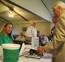 What is this  photo by Jason Schoonover Harlin Elseth  right  looks at a photo album with his granddaughter Jennifer Elseth at an open house at Green Lea