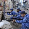 Rapid Action Force personnel take position near the Nariman House at Colaba on Thursday to flush out terrorists holed up at the Chabad house His ordeal was not over  however  The Mumbai