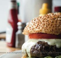 The patties at Ray s Hell Burger are a hefty ten ounces  and the toppings are delicious  Photograph of burger by Scott Suchman