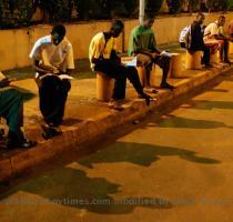 Guinean students study under the lights of the Conakry airport parking lot in June  Though they are dim  the lights are among the few in the electricity starved capital that are sure to be on