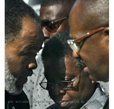 Phyllis Miller  center   grandmother of teenager Jerrod Miller  talks with NAACP spokesman C  Shahid Freeman  left  and attorney Willie Gary  right  after hearing the ruling on Thursday  April