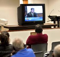 Spectators in an overflow courtroom watch the proceedings in the inquest into the death of 16 year old Jerrod Miller Monday morning  Three televisions were set up in the room that can seat 125