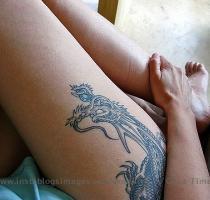 Wake up girls  Here s the dragon that never sleeps  Erotic dragon tattoo on the girl s thigh is amazing and looks appealing  Skinned in the black ink with detailed