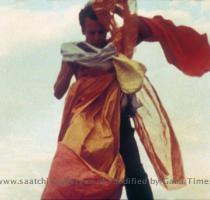 Hélio Oiticica with P4 Parangolé  Cape 1  1964  Still from  HO   a film by Ivan Cardoso  1979  Photo by Ivan Cardoso