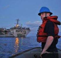 PACIFIC OCEAN  July 24  2009  Boatswain s Mate 3rd Class Thomas McKiernan  assigned to the deck department aboard the aircraft carrier USS George Washington  CVN 73   prepares to approach the