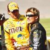 support of our troops  as he waits for the start of the  Great American Race    Front Row Joe  leans on his backup Army Chevrolet  after a crash on Thursday eliminated his first choice   Young Guns  Elliott Sadler  left  and Jamie McMurray  right  talk strategy on pit row