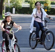 Camp Rock  star Demi Lovato takes advantage of the spring sunshine on a bike ride with her  Desperate Housewives  sister  Madison De La Garza