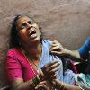 <p>A woman cries on January 10  after a bus accident involving pilgrims to the Sabarimala Shrine in the south western Indian state of Kerala  At least 64 people died and scores were injured Friday in a stampede at a religious festival in southern India triggered by a vehicle crashing into a crowd  officials said < p>